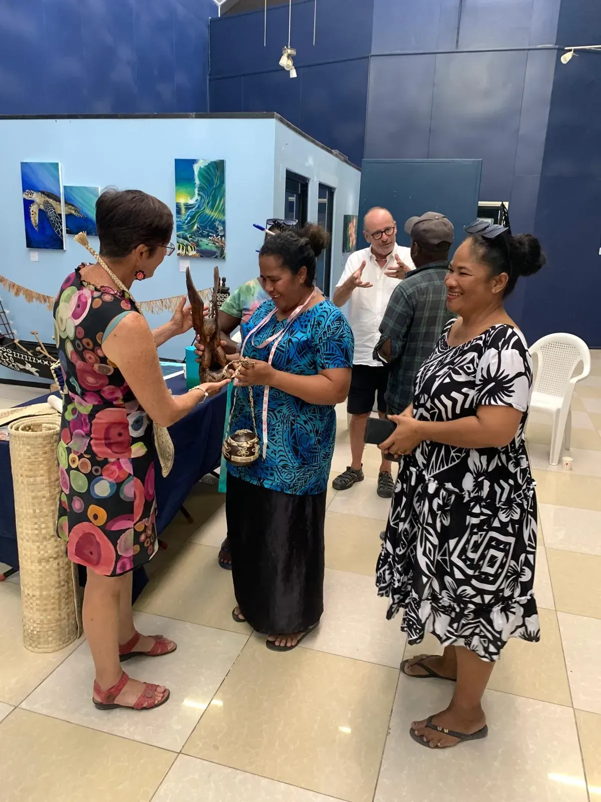 People talking and looking at crafts